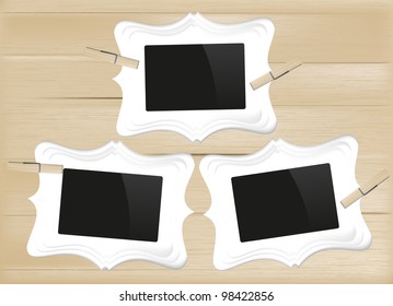 shaped photo frames on wood background
