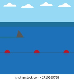 Shark swimming behind buoys in the sea