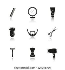 Shaving accessories drop shadow black icons set. Barbershop equipment. Comb, mirror, aftershave tube, electric shaver, razor, beard, scissors, shaving brush, hairdryer. Isolated vector illustrations