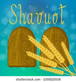 Shavuot. Concept of Judaic holiday. Tablets of the covenant of Moses Bible Torah. Ten Commandments. Ears of wheat. Blue background, blur