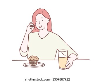 
She ordered drinks and bread and is talking on the phone.