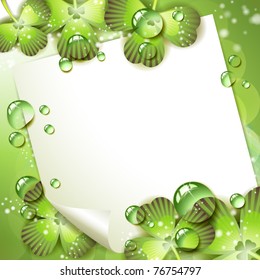 Sheet of paper and clover over springtime background