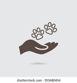 Shelter pets sign icon. Hand holds paw symbol. Animal protection
