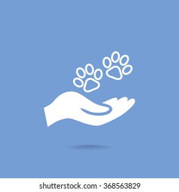 Shelter pets sign icon. Hand holds paw symbol. Animal protection