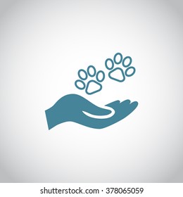 Shelter pets sign icon. Hand holds paw symbol. Animal protection