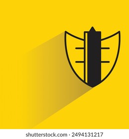 insignia de escudo con sombra sobre fondo amarillo