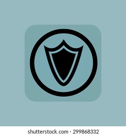 Shield in circle, in square, on pale blue background