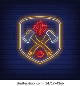 Shield with crossed axes and maple leaf neon sign. Canada, autumn, advertisement design. Night bright neon sign, colorful billboard, light banner. Vector illustration in neon style.