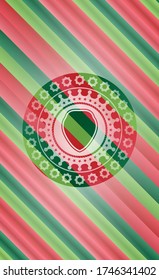 shield icon inside christmas colors badge. 