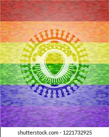 shield icon inside emblem on mosaic background with the colors of the LGBT flag