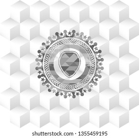 shield icon inside grey emblem with geometric cube white background