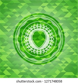 shield icon inside realistic green emblem. Mosaic background