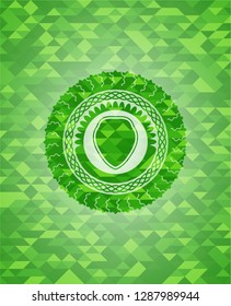 shield icon inside realistic green mosaic emblem