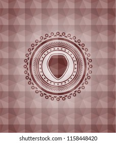 shield icon inside red seamless emblem with geometric pattern.