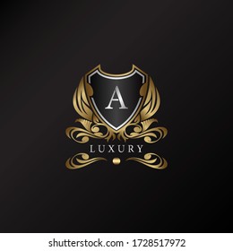 Shield logo in gold color with letter A Logo. Elegance logo vector template made of wide silver alphabet font on shield frame ornate style.
