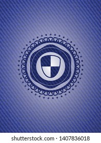 shield, safety icon inside badge with denim background