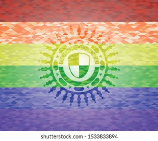 shield, safety icon inside emblem on mosaic background with the colors of the LGBT flag