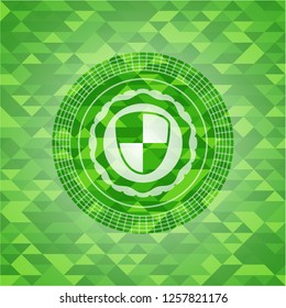 shield, safety icon inside green mosaic emblem