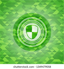 shield, safety icon inside green mosaic emblem