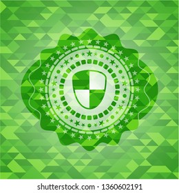 shield, safety icon inside green emblem with mosaic ecological style background