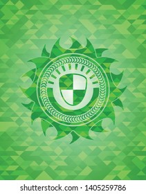 shield, safety icon inside green emblem. Mosaic background