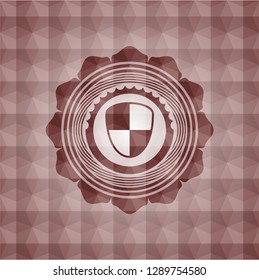 shield, safety icon inside red seamless emblem with geometric pattern background.