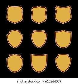 Shield shape gold icons set. Simple flat logo on black background. Symbol of security, protection, safety, strong. Element badge for protect design emblem decoration. Vector illustration