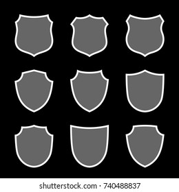 Shield shape icons set. Gray label sign, isolated on black. Symbol of protection, arms, coat honor, security, safety. Flat retro style design. Element vintage heraldic emblem Vector illustration