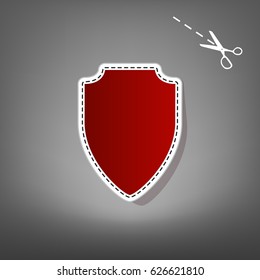 Shield sign illustration. Vector. Red icon with for applique from paper with shadow on gray background with scissors.