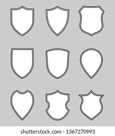 Shields graphic icons set. Blank heraldic shields signs isolated on gray background. Web protection symbols. Vector illustration