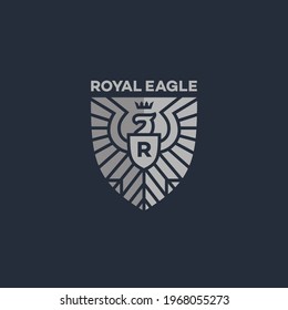 Shield-shaped eagle heraldic logo design template. Vector illustration.