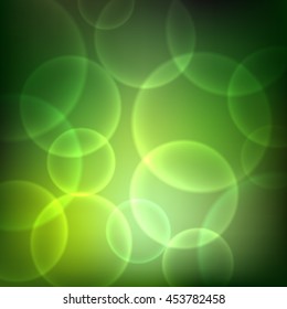 Shining green background with light effects. Magic defocused glitter sparkles. Blurred soft backdrop. Vector illustration. EPS10