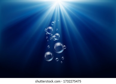 Shining sun in deep blue sea underwater with air bubbles. deep blue ocean in underwater