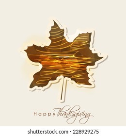 Shiny beautiful maple leaf for Happy Thanksgiving Day celebration on grey background.