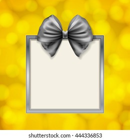 shiny bow and square box frame on blurry golden background. vector illustration