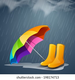 Shiny bright colors decorated open umbrella and long boots in under heavy rain. 