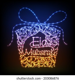 Shiny colorful floral decorated gift box on blue background for the occasion of Muslim community festival Eid Mubarak celebrations. 