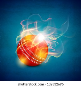 Shiny cricket ball in flame on blue background.