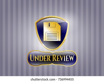  Shiny emblem with diskette icon and Under Review text inside