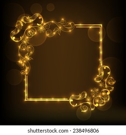 Shiny frame decorated by beautiful golden floral pattern on brown background.