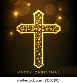 Shiny golden Christian Cross for Merry Christmas celebration on abstract brown background.