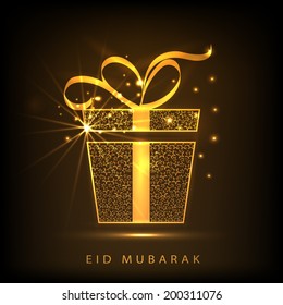 Shiny golden gift box with ribbon on brown background for muslim community festival Eid Mubarak celebrations. 