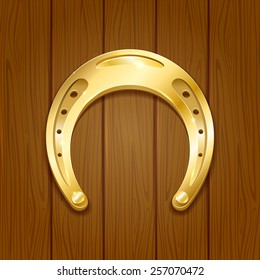 Shiny golden horseshoe on wooden background, illustration.