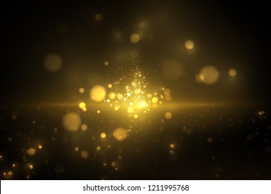 Shiny golden particles on dark. Glowing yellow bokeh abstract luxury background