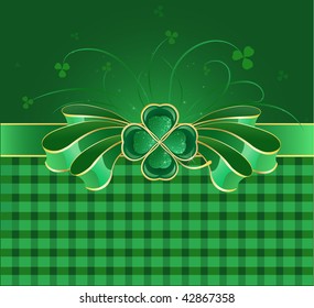 shiny green bow with gilded green decoration in the form of clover with four leaves on a green background with a checkered pattern
