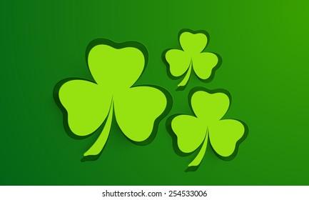 Shiny green shamrock leaves background for St. Patrick's Day celebrations. 
