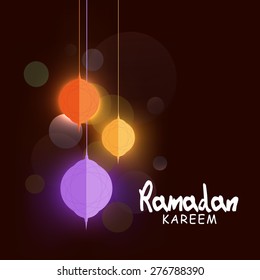 Shiny hanging paper lanterns, concept for Islamic holy month of prayers Ramadan Kareem celebrations. 