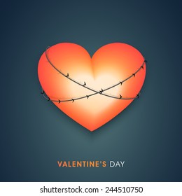 Shiny heart tied by barbed wire on blue background for Valentines Day.