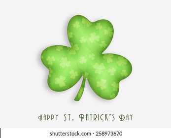 Shiny Irish lucky shamrock leaf on grey background for Happy St. Patrick's Day celebration.