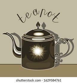 Shiny metallic teapot with shadow on a gray isolated background with the lettering